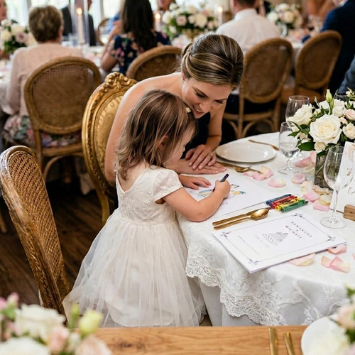 Little guest coloring her personalized booklet at the wedding reception